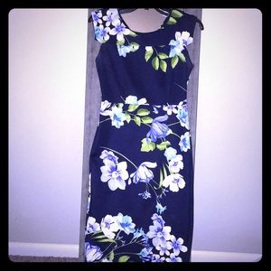 Long fitted blue and flowered dress.